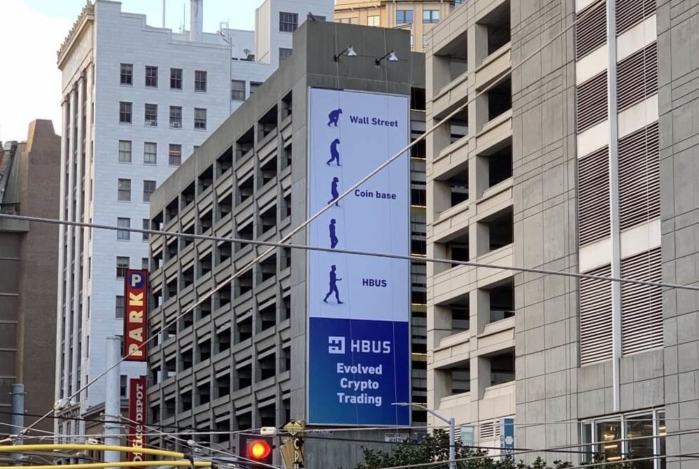 HBUS takes a shot at Coinbase with billboard ad.